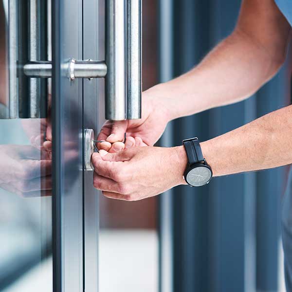 Shot of a Male Locksmith installing a Lock